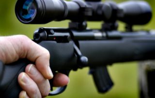 Elk Hunting Gear: An up close view of a black rifle with a scope.